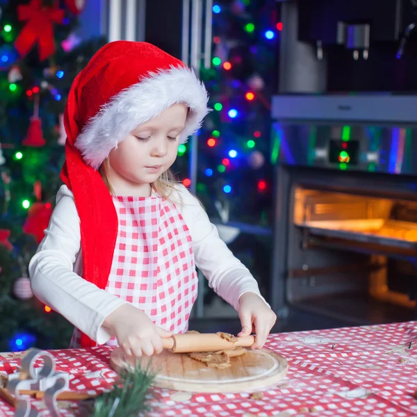 Porträtt av liten flicka med brödkavel bakning jul pepparkakor — Stockfoto