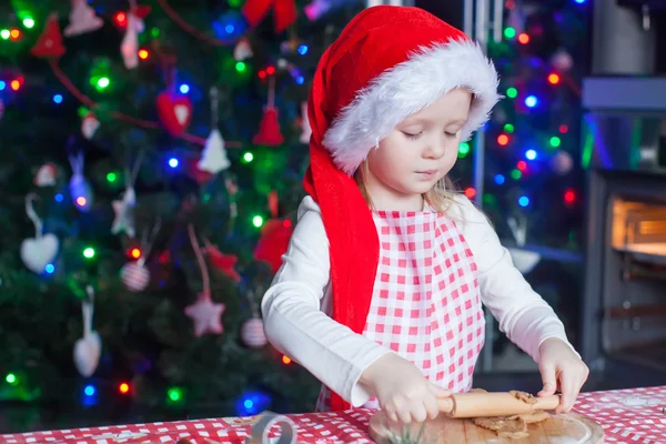 Little girl with rolling pin baking Christmas gingerbread cookies — Stock Photo, Image