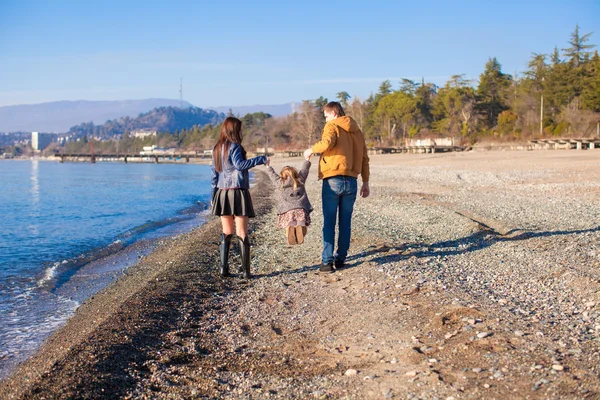 Famiglia di tre persone che passeggiano lungo il Mar Nero in inverno giornata di sole — Foto Stock