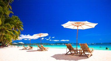 cennet görünümü güzel tropik boş kumlu Plage şemsiye ve plaj sandalyesi ile
