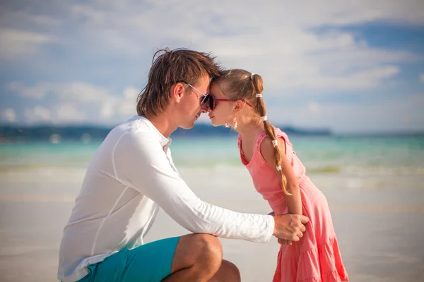 Entzückendes kleines Mädchen und junger Vater haben Spaß am weißen Sandstrand — Stockfoto