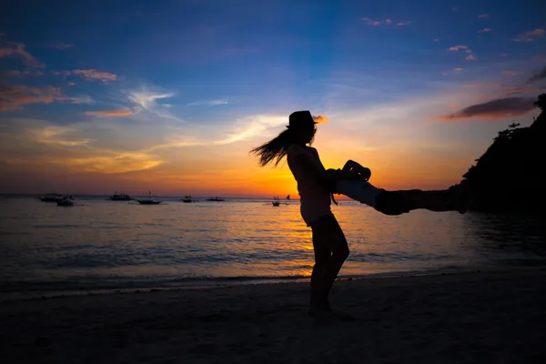 Little girl and her mother having fun at sunset on the island Boracay, Philippines — Stock Photo, Image