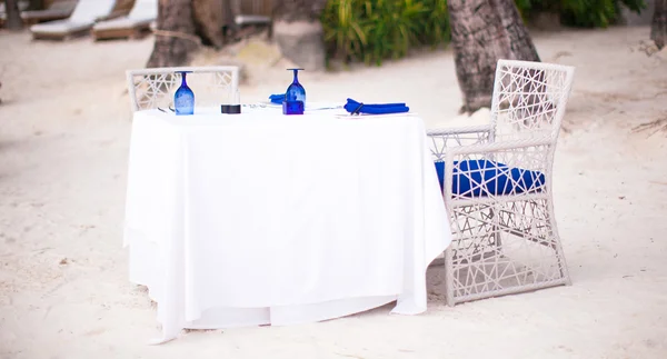 Summer empty open air table set for dinner on white beach — Stock Photo, Image