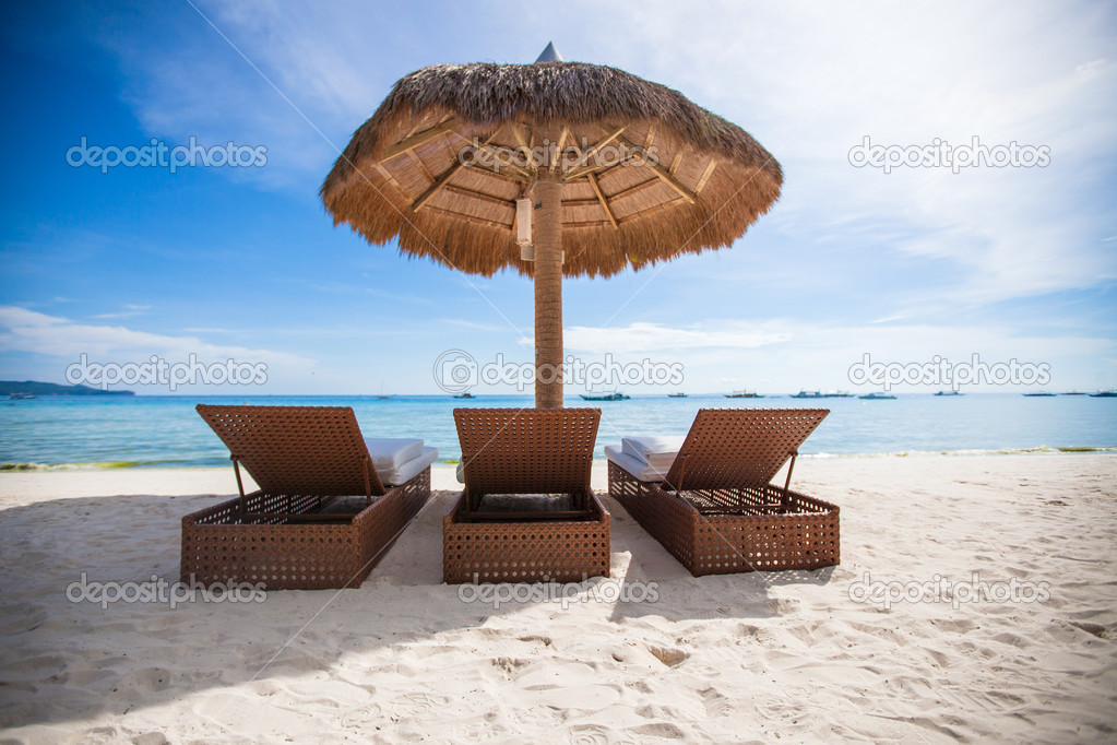 Paradise view of nice tropical empty sandy plage with umbrella and beach chair