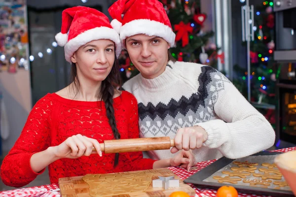 Young happy couple baking Christmas cakes Royalty Free Stock Images