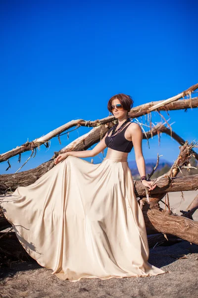 Adorable young woman in a beautiful dress on the beach — Stock Photo, Image