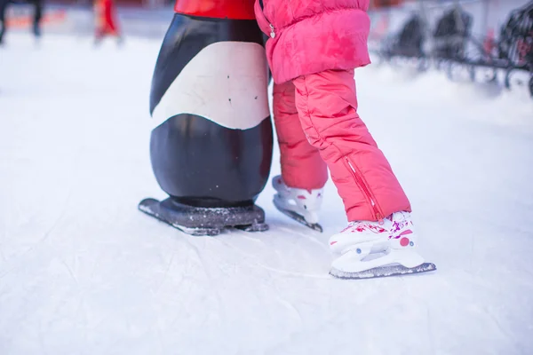 Little skater's legs standing on winter ice rink — Stock Photo, Image