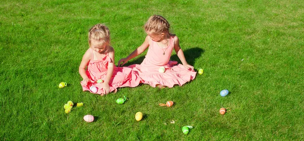 Two adorable little girls playing with Easter Eggs — Stock Photo, Image