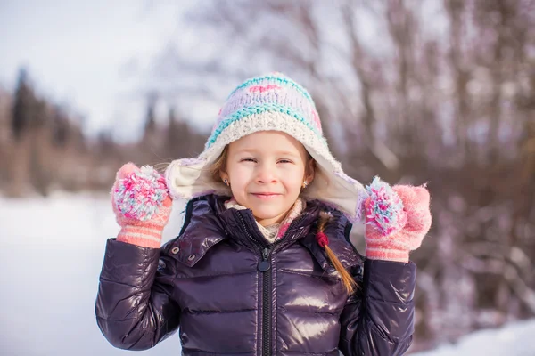 Portrait of little adorable happy girl in the snow sunny winter day — Stock Photo, Image