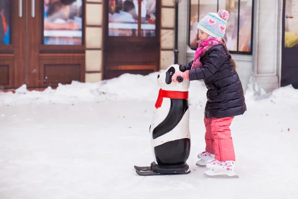 Adorable happy little girl enjoying skating at the ice-rink — Stock Photo, Image