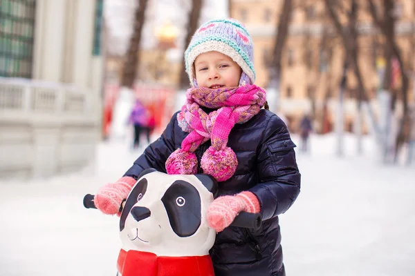 Adorable little happy girl skating on the ice-rink — Stock Photo, Image