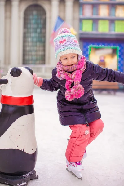 Adorable happy little girl enjoying skating at the ice-rink — Stock Photo, Image