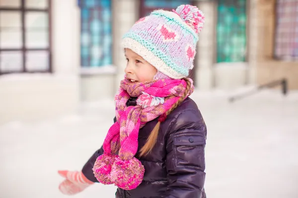 Adorable little happy girl skating on the ice-rink — Stock Photo, Image