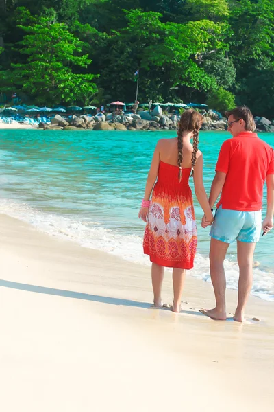 Rückansicht eines jungen Paares, das sich an einem tropischen Strand genießt — Stockfoto