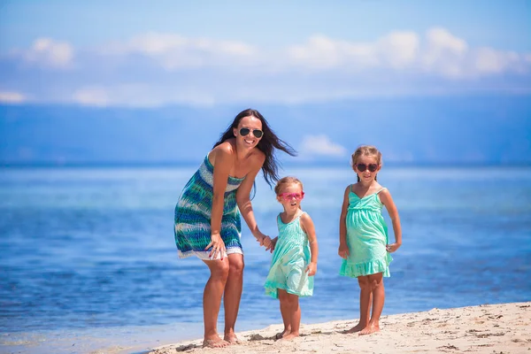 Adorable little girls and young mother have fun on tropical white beach in desert island — Stock Photo, Image