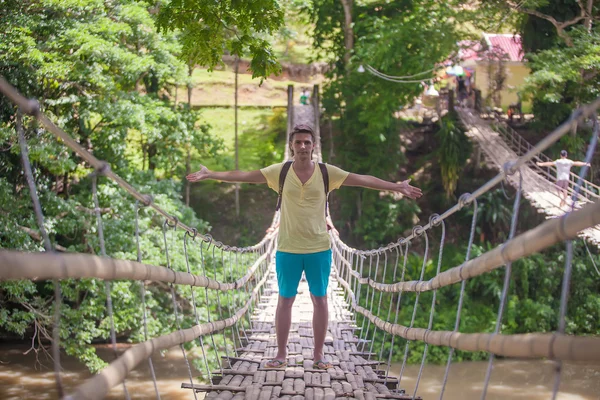 Young guy on suspension bridge over the River Loboc, Philippines — Stock Photo, Image