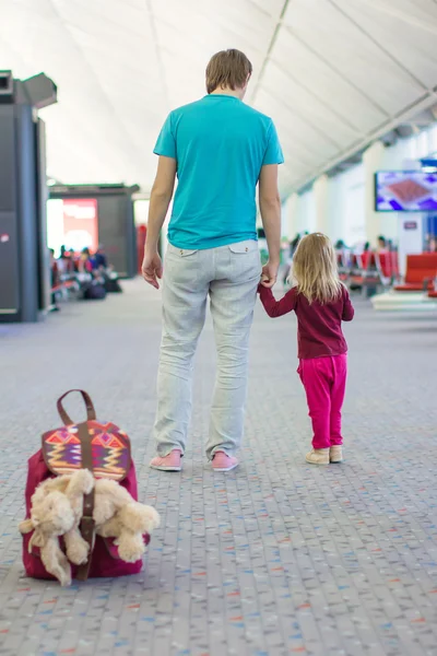 Rückansicht eines kleinen Mädchens und eines jungen Vaters im Flughafen, die auf einen Flug warten — Stockfoto