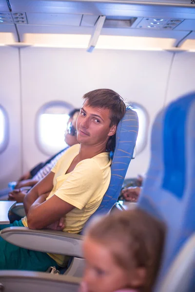 Mladý muž v letadle během letu — Stock fotografie
