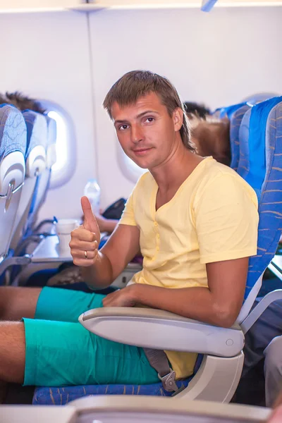 Young man in an airplane during flight — Stock Photo, Image