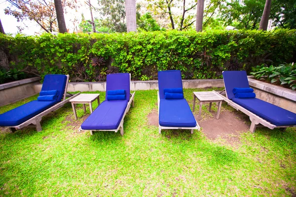 Beach chairs in exotic resort near swimming pool — Stock Photo, Image