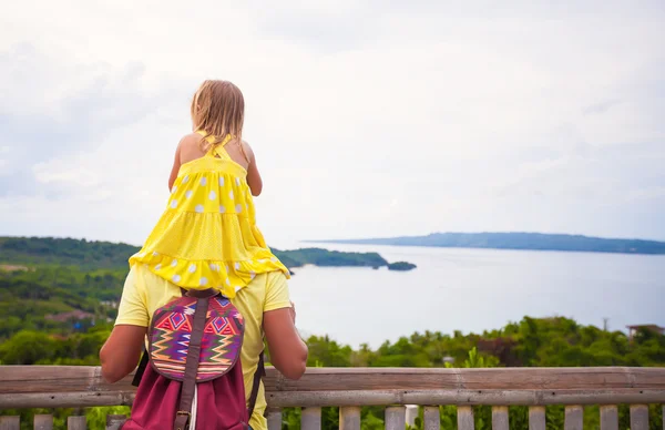Little girl riding on her dad background the amazing panoramic view of Boracay island — Stock Photo, Image