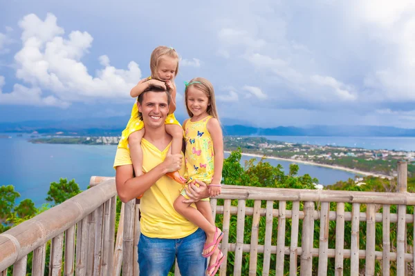 Smiling family at observation deck on the background of beautiful scenery — Stock Photo, Image