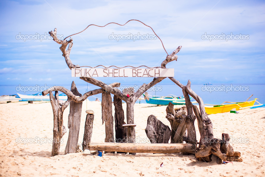 Title Puka beach on background blue sky in Boracay island