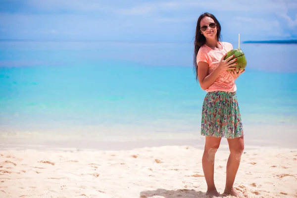 Young beautiful woman with coconut cocktail on white tropical beach — Stock Photo, Image