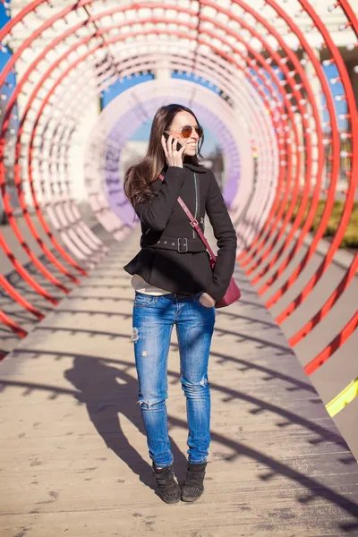 Young buzy happy woman talking on the phone outdoors — Stock Photo, Image