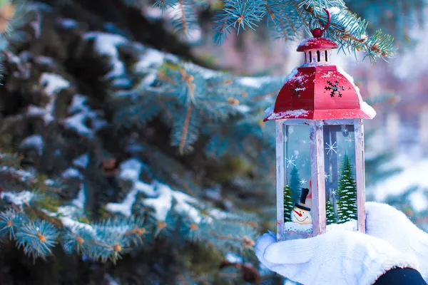 Beautiful red vintage Christmas lantern on warm mittens — Stock Photo, Image