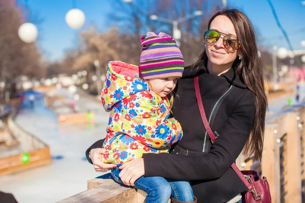 Portarit of little cute girl with her mother on sunny day outdoors — Stock Photo, Image