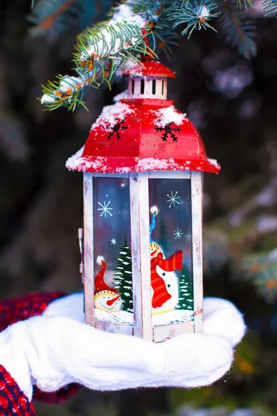 Beautiful red vintage Christmas lantern on warm mittens — Stock Photo, Image