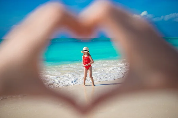 Close up of heart made by female hands background little girl — Stock Photo, Image