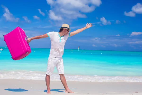 Young man walking with his bag on tropical white beach — Stock Photo, Image