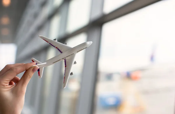 Close up hand holding an airplane model — Stock Photo, Image