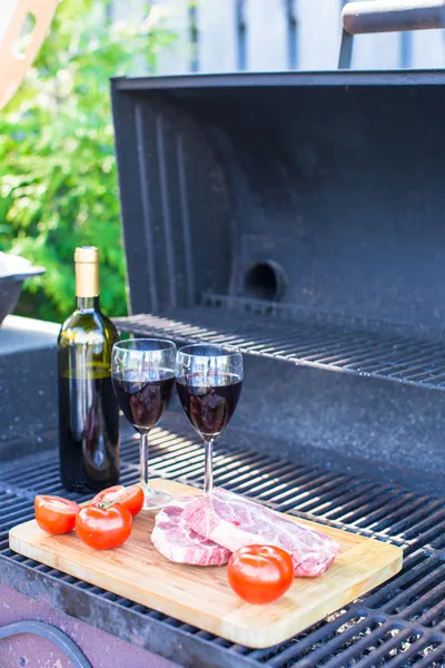 Čerstvé maso, zelenina a láhev vína na piknik venku — Stock fotografie
