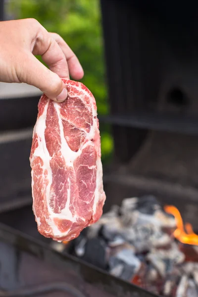 Juicy raw steak on barbecue background outdoor — Stock Photo, Image