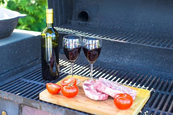 Frisches Fleisch, Gemüse und eine Flasche Wein bei einem Picknick im Freien — Stockfoto