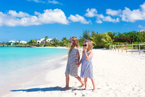 Little adorable girls on white beach walking by the sea — Stock Photo, Image