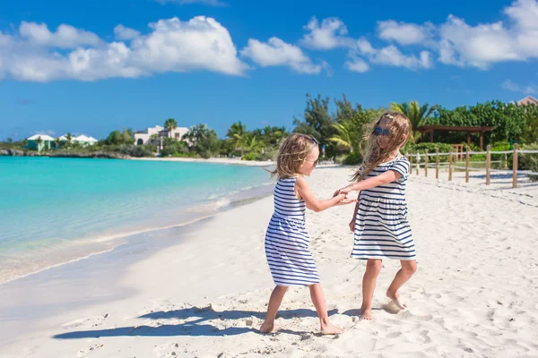 Little cute girls walking along the white beach and having fun — Stock Photo, Image