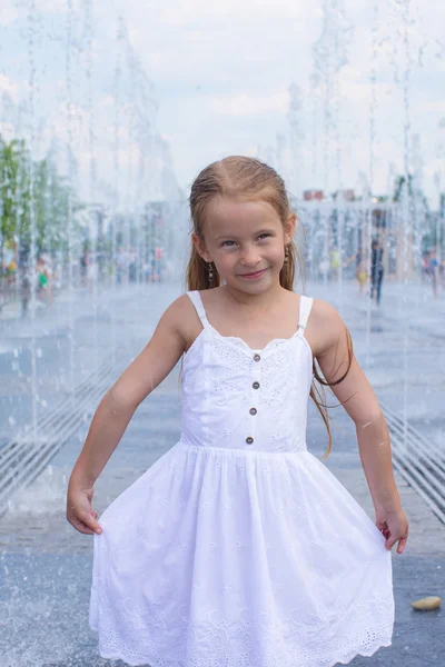 Portrait of little happy girl have fun in street fountain at hot sunny day — Stock Photo, Image