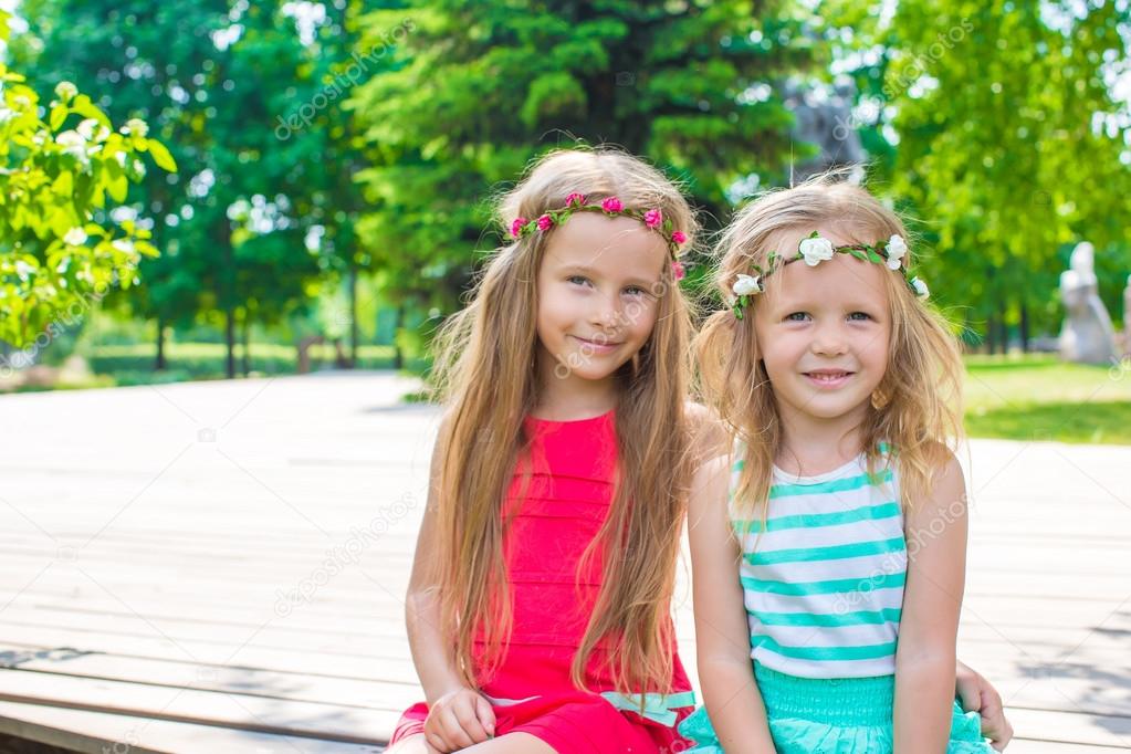 Portrait of adorable little girls on warm summer day