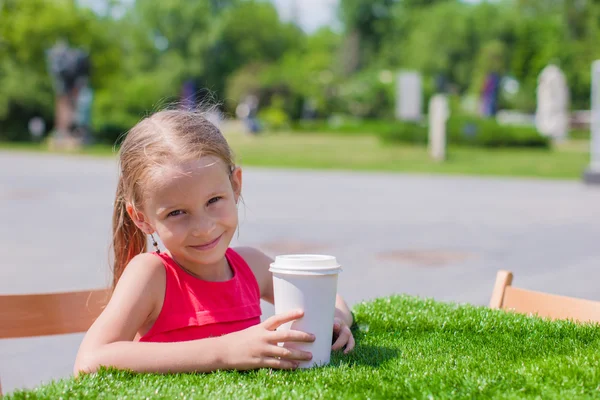 Little adorable girl at outdoor cafe on warm summer day — Stock Photo, Image