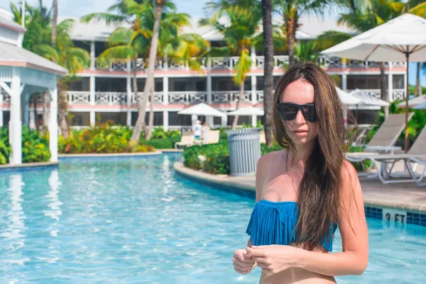 Jovem mulher bonita relaxando na piscina no resort exótico — Fotografia de Stock