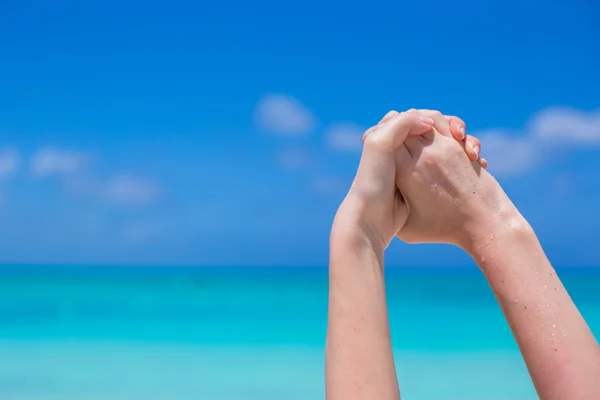 Closeup of hands making handshake background turquoise water — Stock Photo, Image