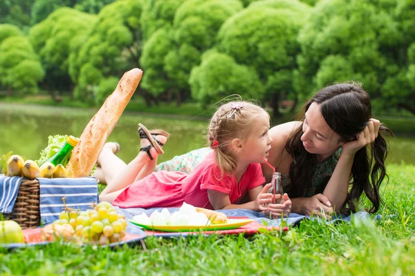 Mother with daughter picnicking in the park outdoor — Stock Photo, Image