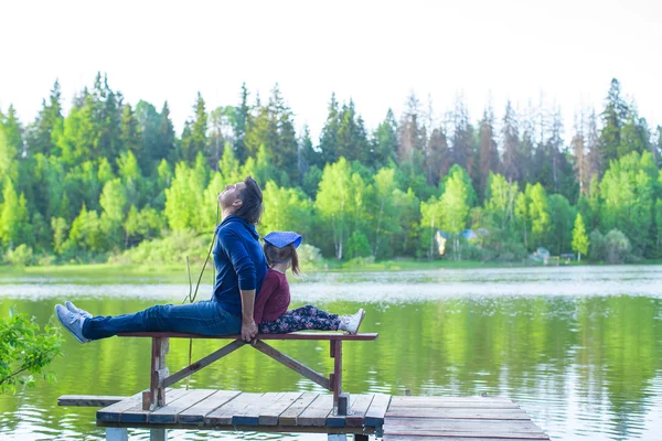 Young dad and his little daughter on pier by the lake — Stock Photo, Image