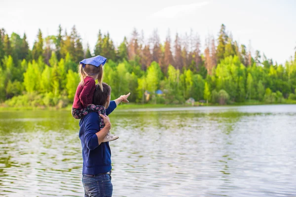 Young father and little adorable girl fishing on the river — Stock Photo, Image