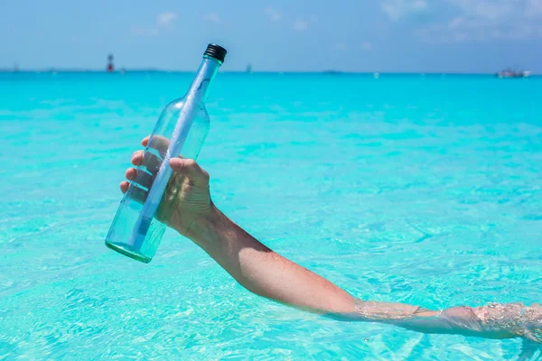 Bottle with message at the hand — Stock Photo, Image