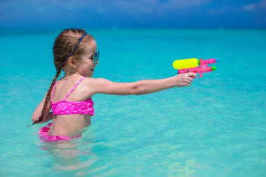 Karayipler tatil sırasında kumsalda oynarken mutlu küçük kız
